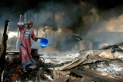 A man rinses soot from his face at the scene of a petrol pipeline explosion in Lagos, Nigeria.