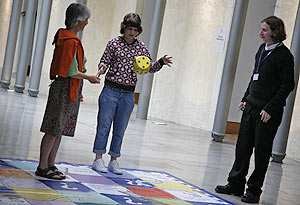 Woman throws the dice on political snakes and ladders. 