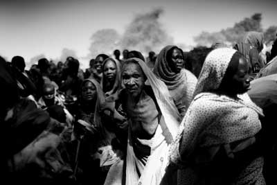 Displaced people wait for food distribution near the village of Habile, in Chad. 
